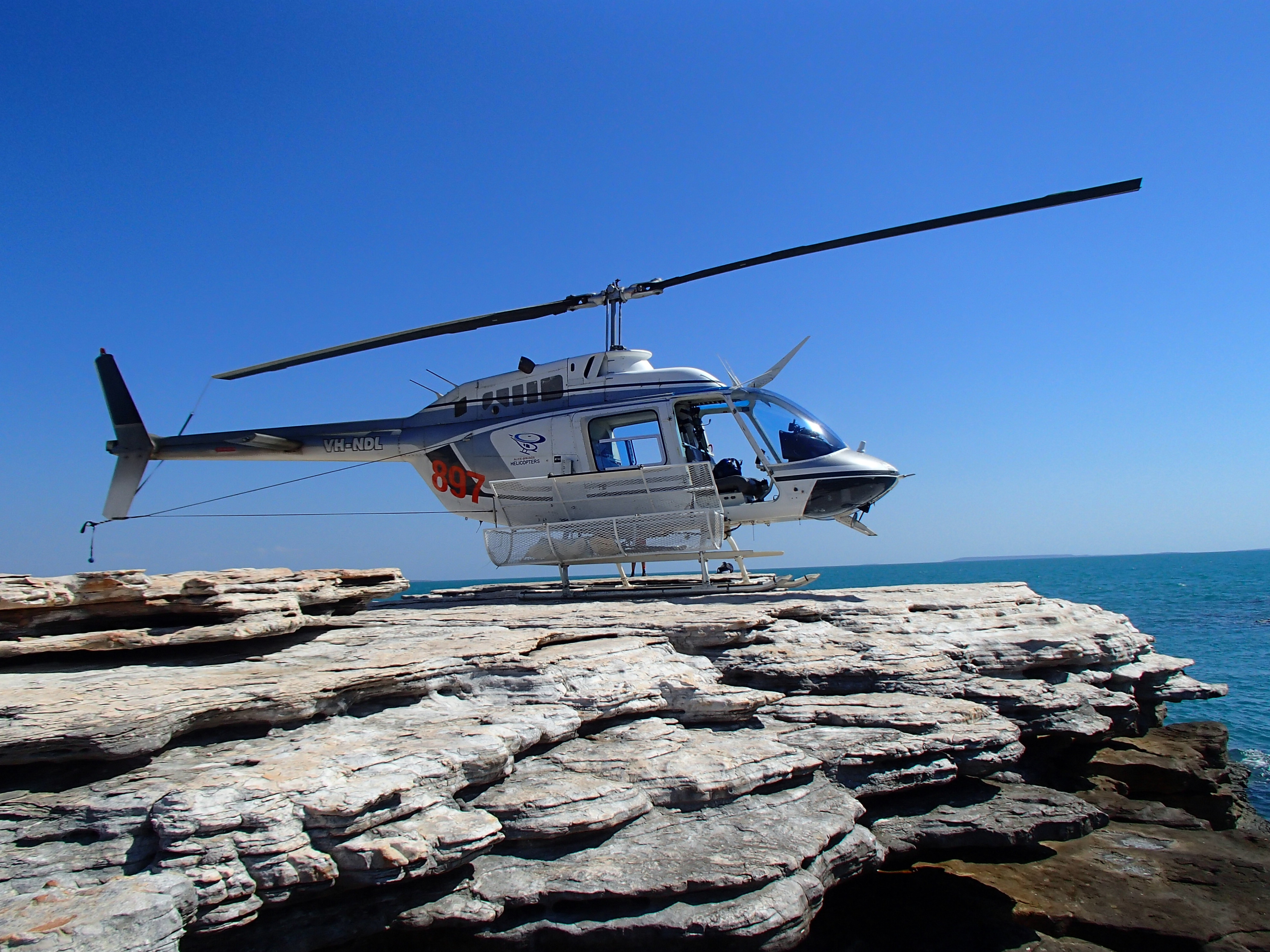 Helicopter sampling allows access to small offshore islands in the Timor Sea off the north coast of the Kimberley region in northern Western Australia. Proterozoic sedimentary rocks are essentially undeformed and offer a wide range of landing sites. - Paul Morris, Gov of WA